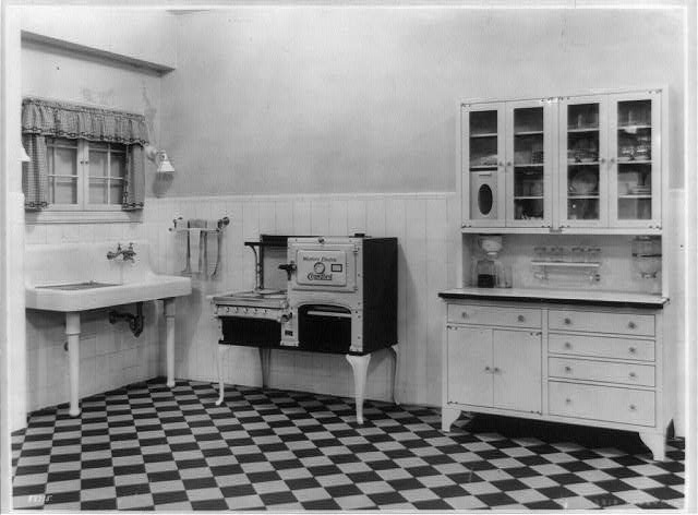 Sink, Western Electric stove, and cabinet in a model kitchen